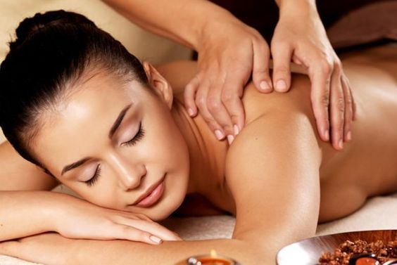 woman receiving a massage at her shoulder